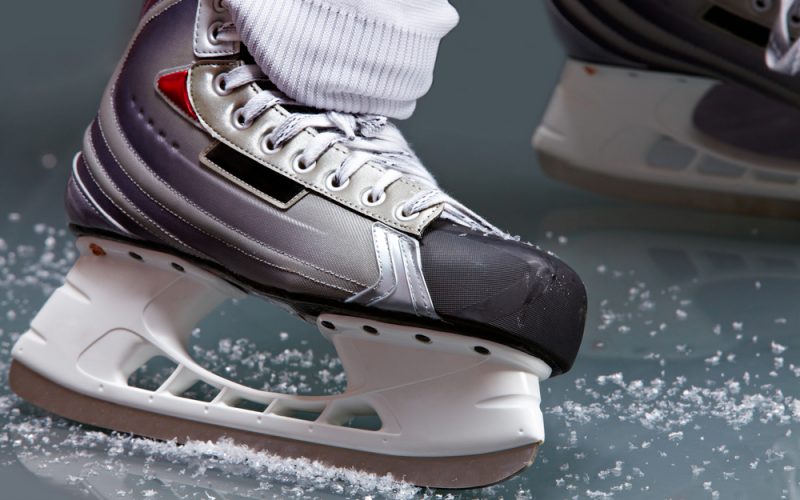 Close-up of skates on player feet during ice hockey